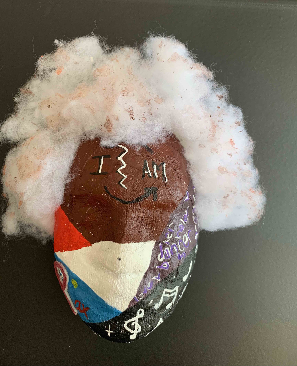 Mask sculpture with puffy white hair