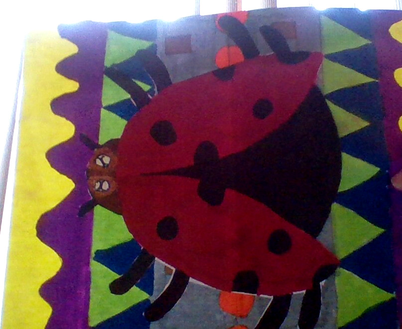 drawing of a ladybug on a patterned background
