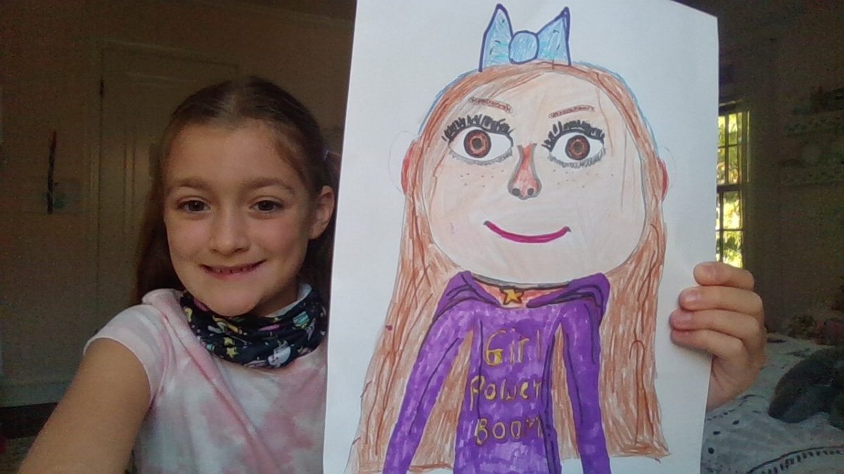 Photo of a girl holding up a self-portrait