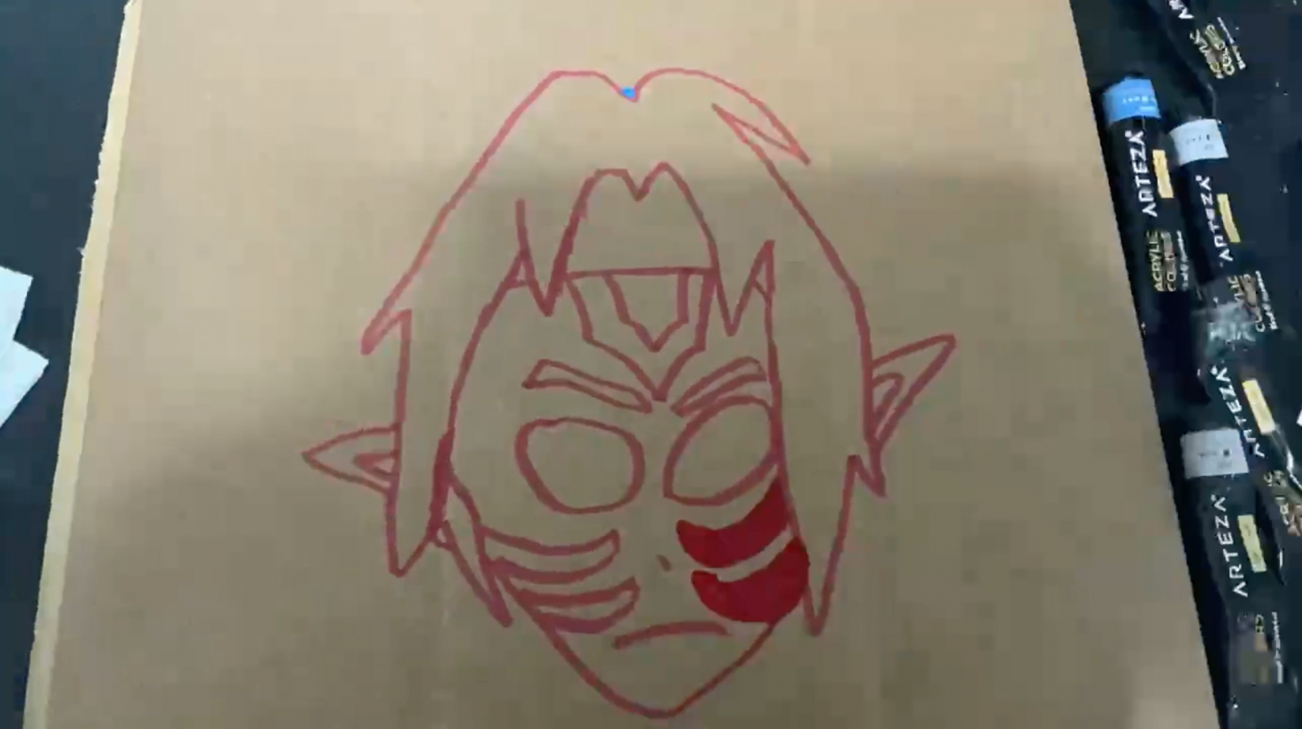 Red outline drawing of a boy with face paint