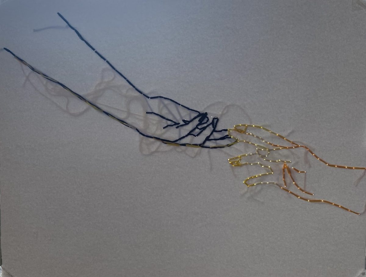 Embroidery of two hands touching