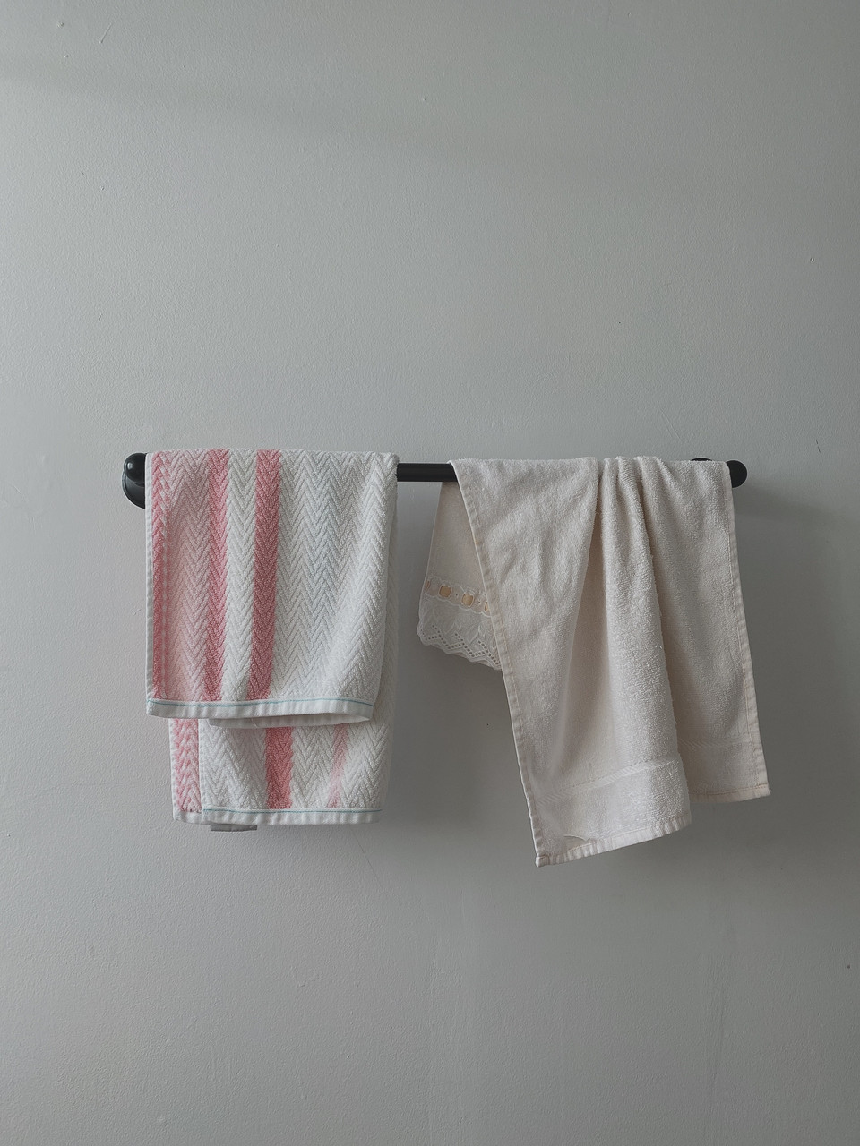 Photograph of two towels hanging on a bar