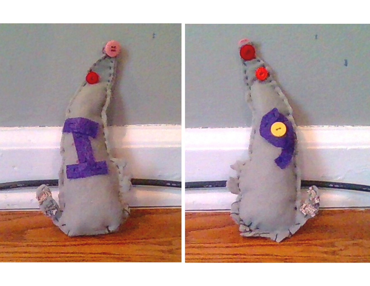 A gray rat plushie with purple I and purple 9 stitched to its body