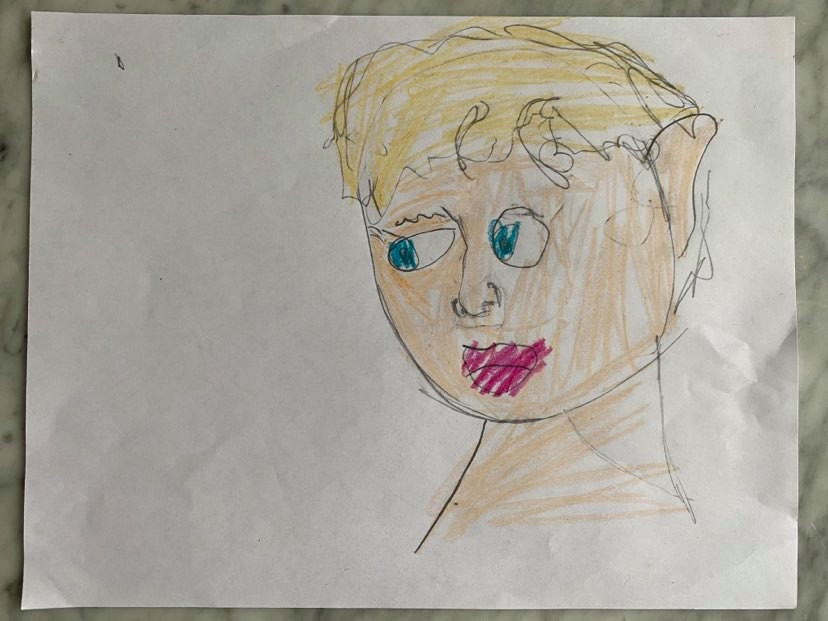 A drawing of a boys face with blonde hair and blue eyes