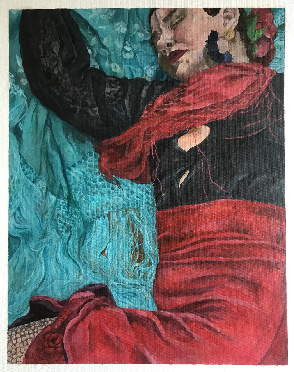 person in black and red dress lays on blue sheets.