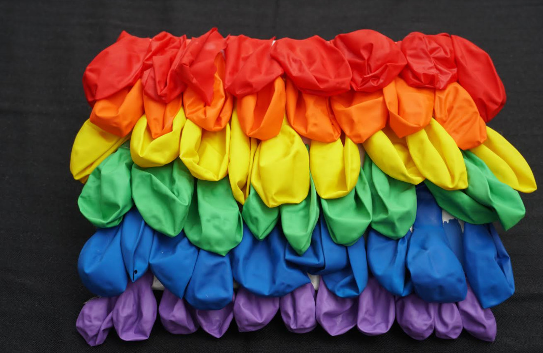 Balloons arranged in a rainbow pattern