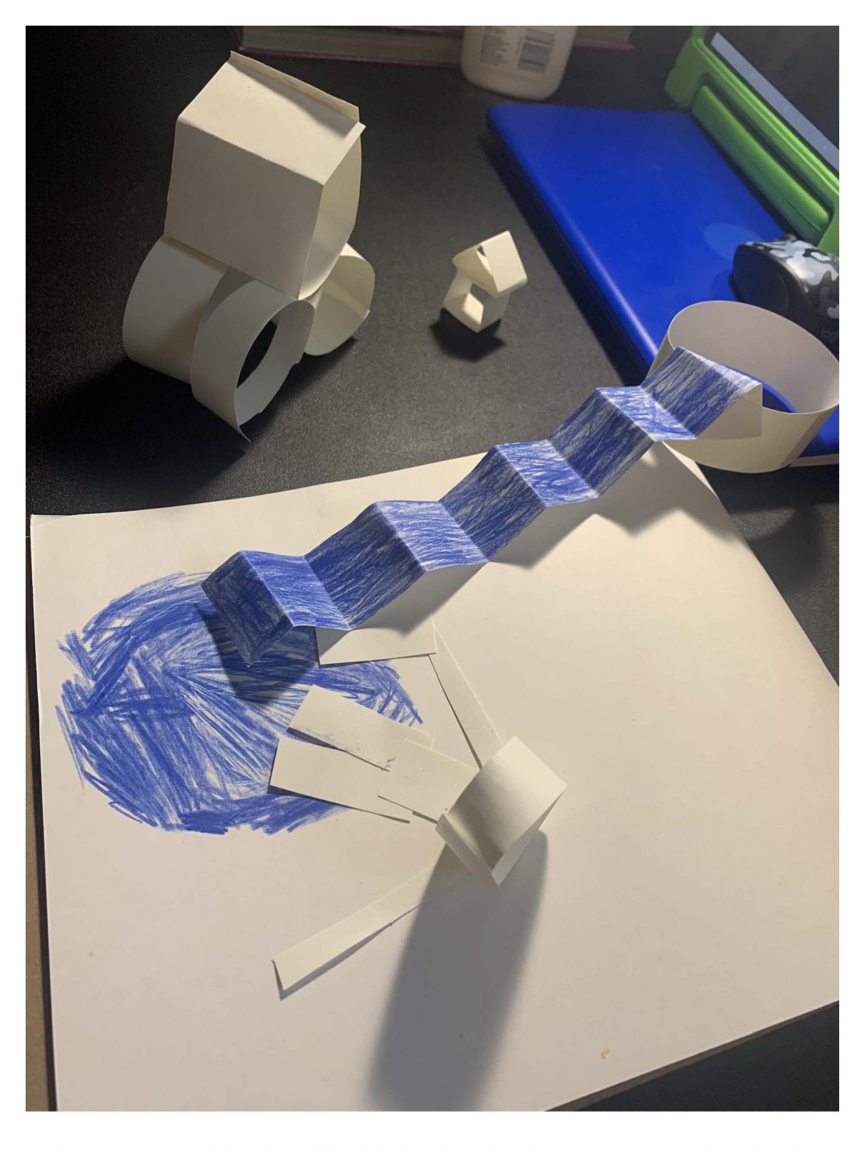 sculpture of white paper with blue "river"