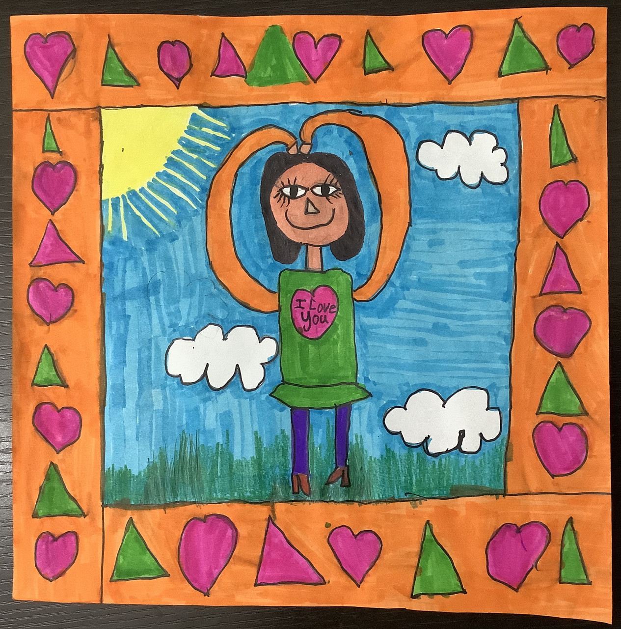 Drawing of a girl with a sun and grass, surrounded by a decorative frame