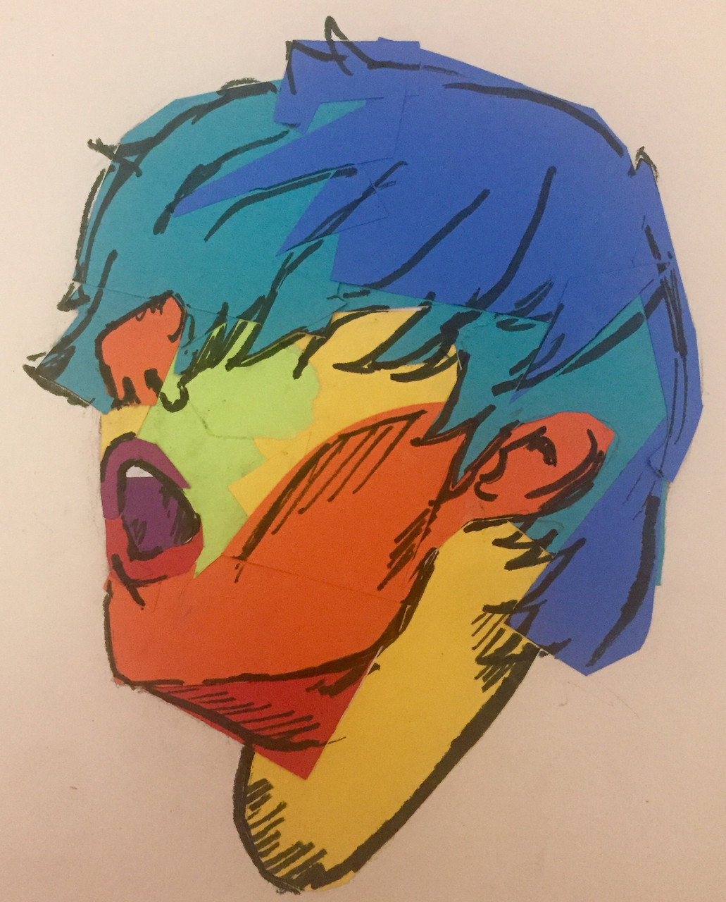 Boy yelling with different colors all over his face