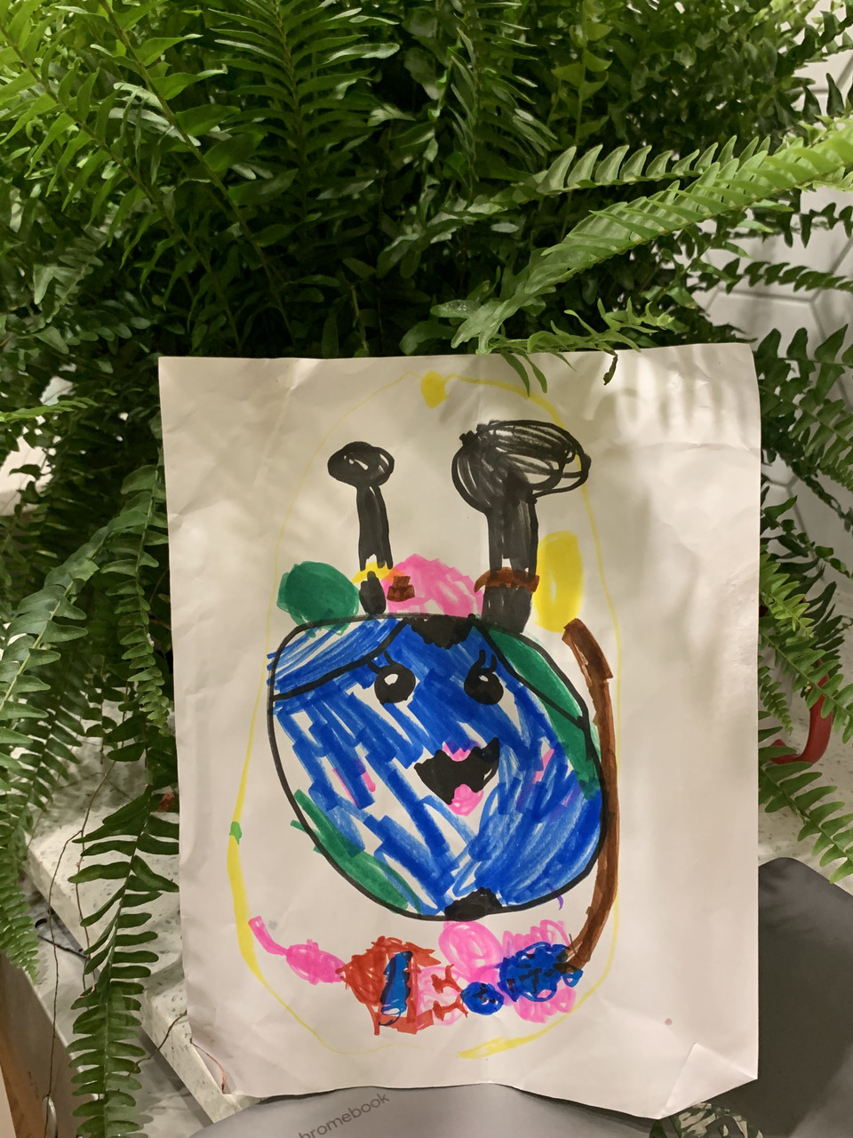 A drawing of a blue circle with a face