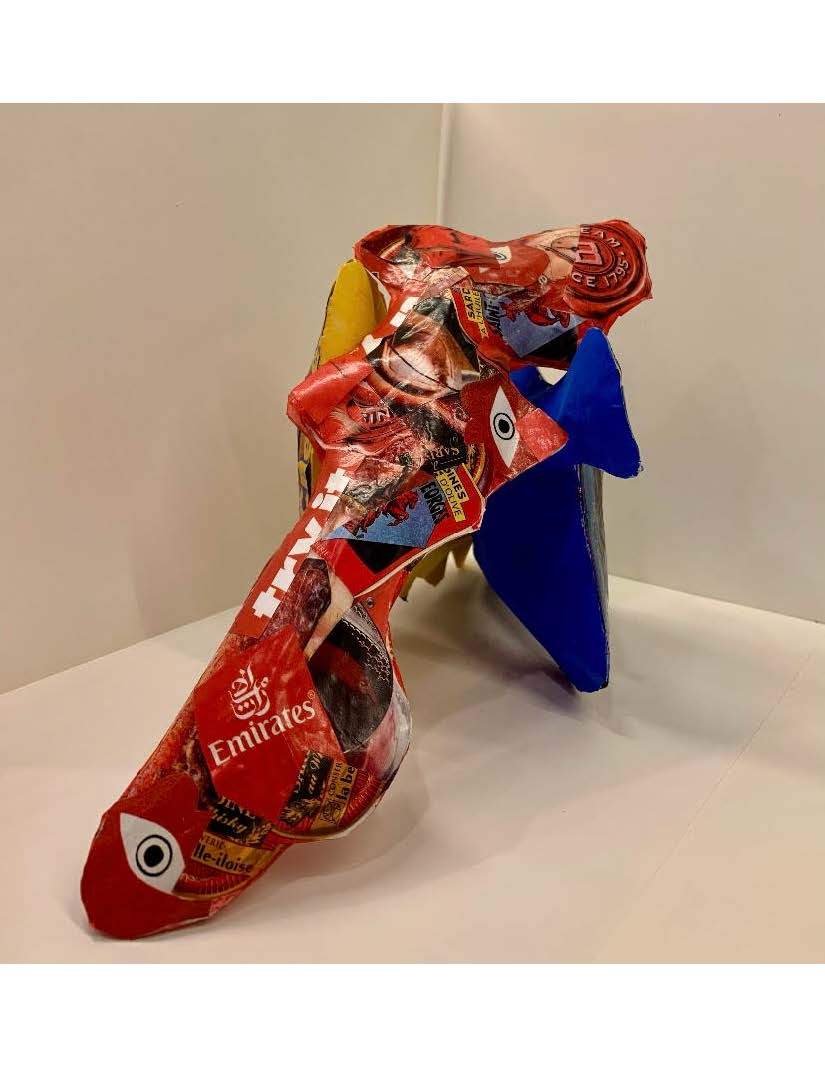 An abstract sculpture with mixed materials of red, yellow, and blue