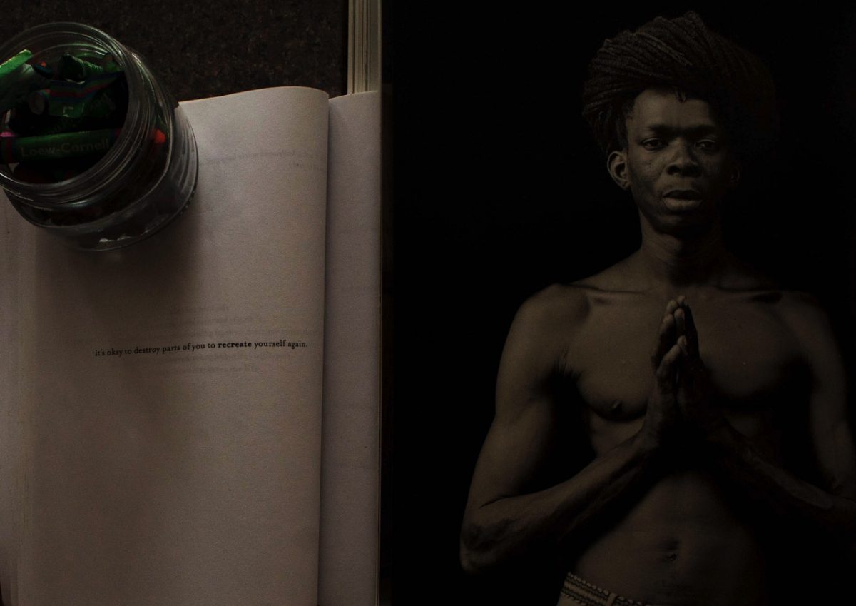 Split photograph of a book on the left and a man with his hands in the praying sign on the right