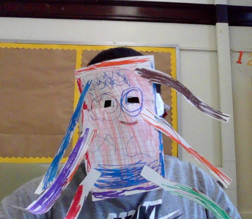 Student wearing a mask made of paper that has been colored