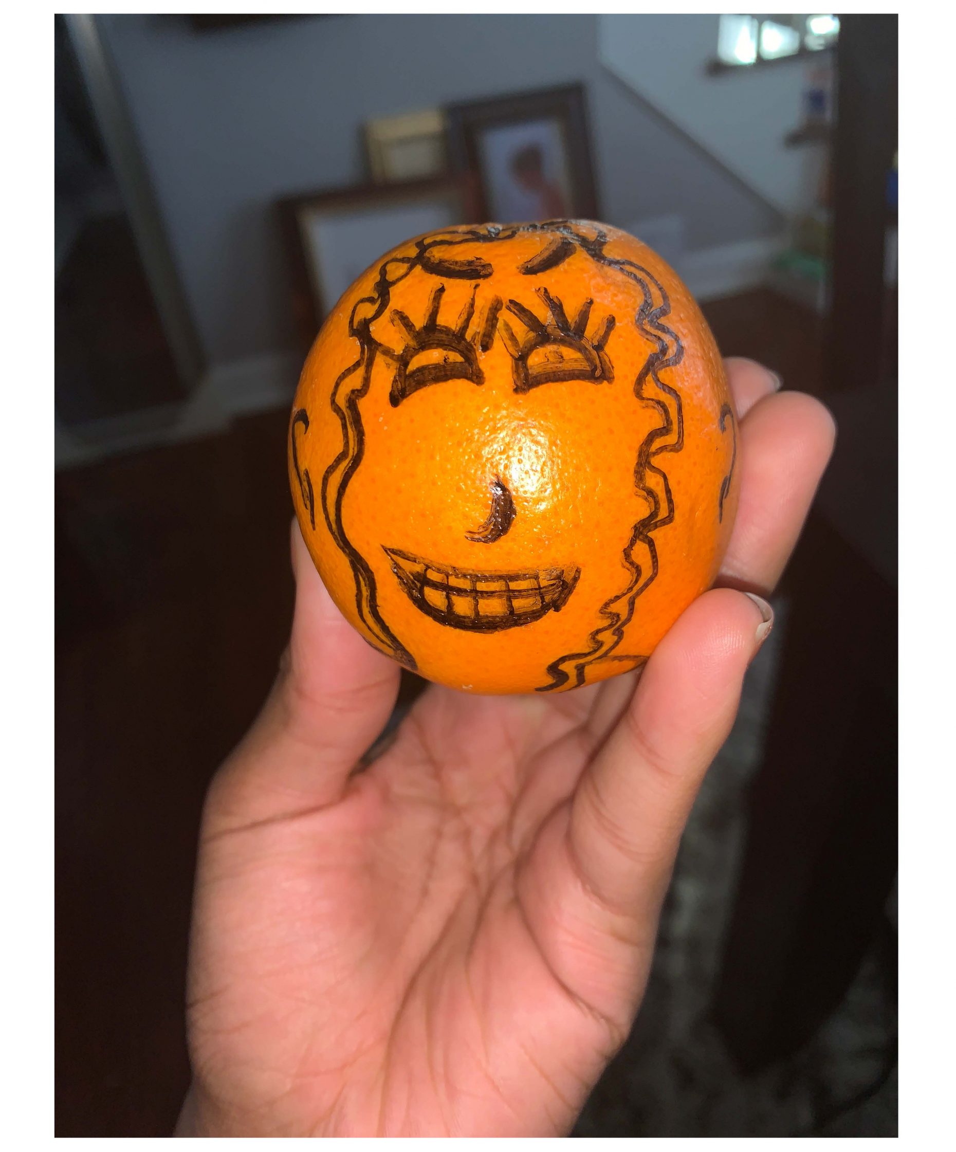 Orange with a face drawn on it