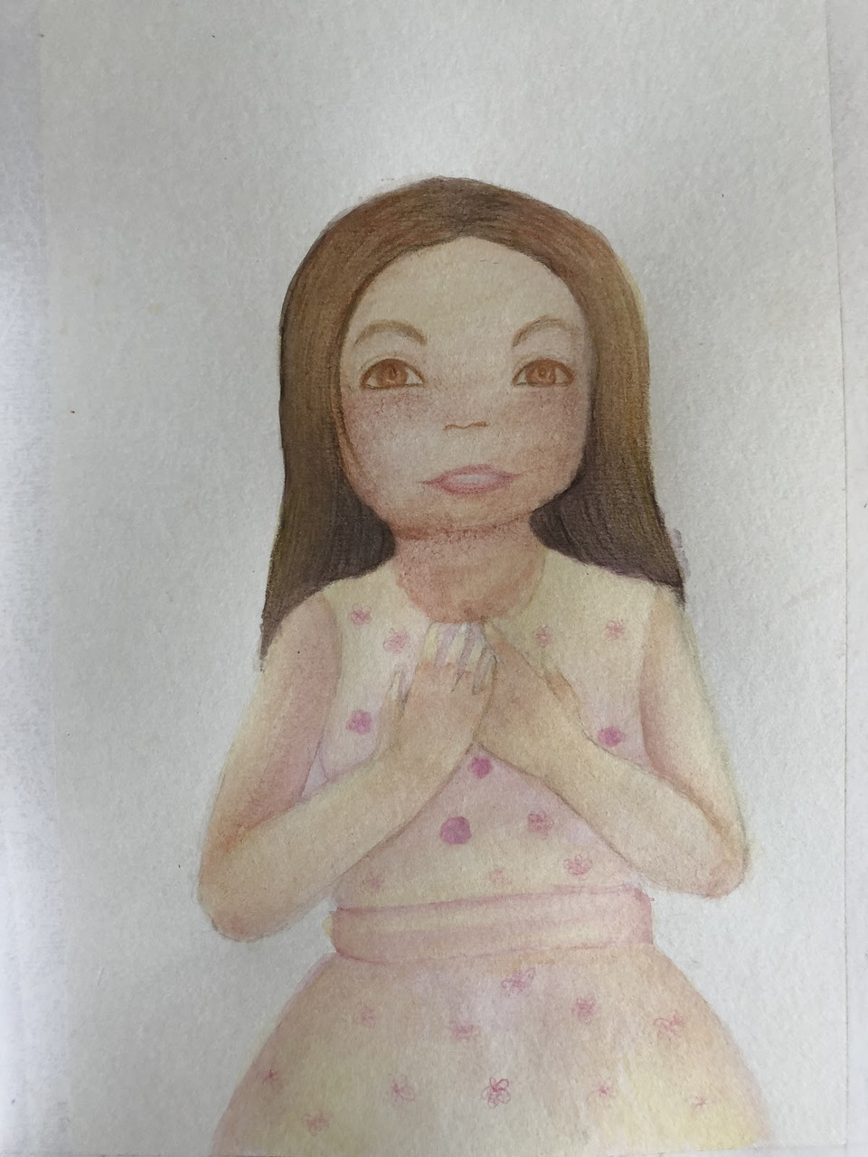 Drawing of a young girl with brown hair wearing a pink dress