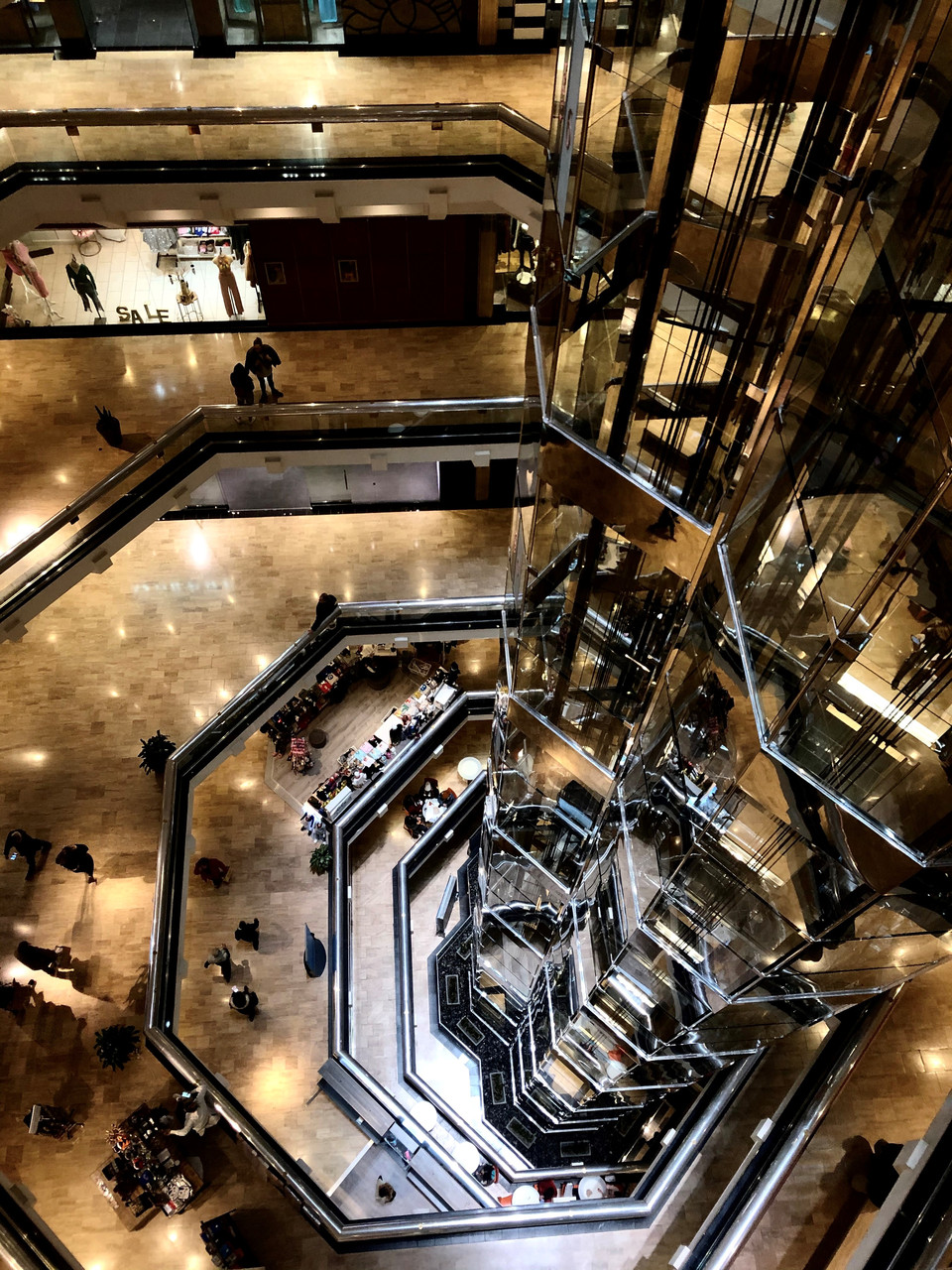 A photograph of the inside of a building looking down from a top floor