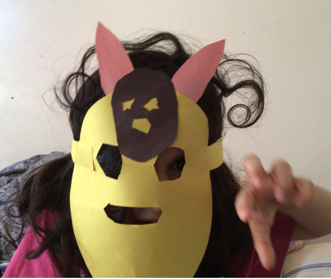 Photograph of a student wearing a cut-paper mask