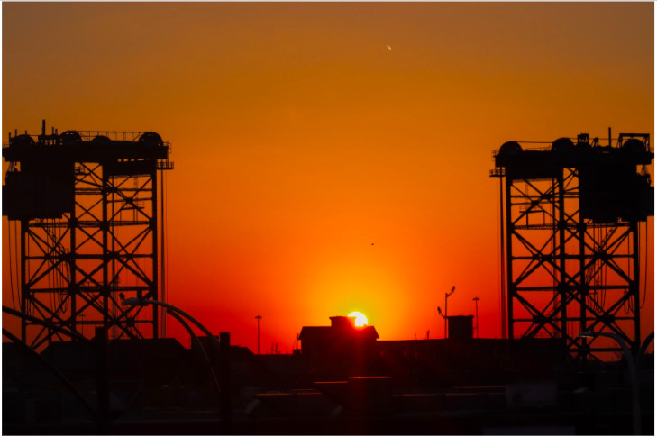 Photo of sunset over industrial bridge