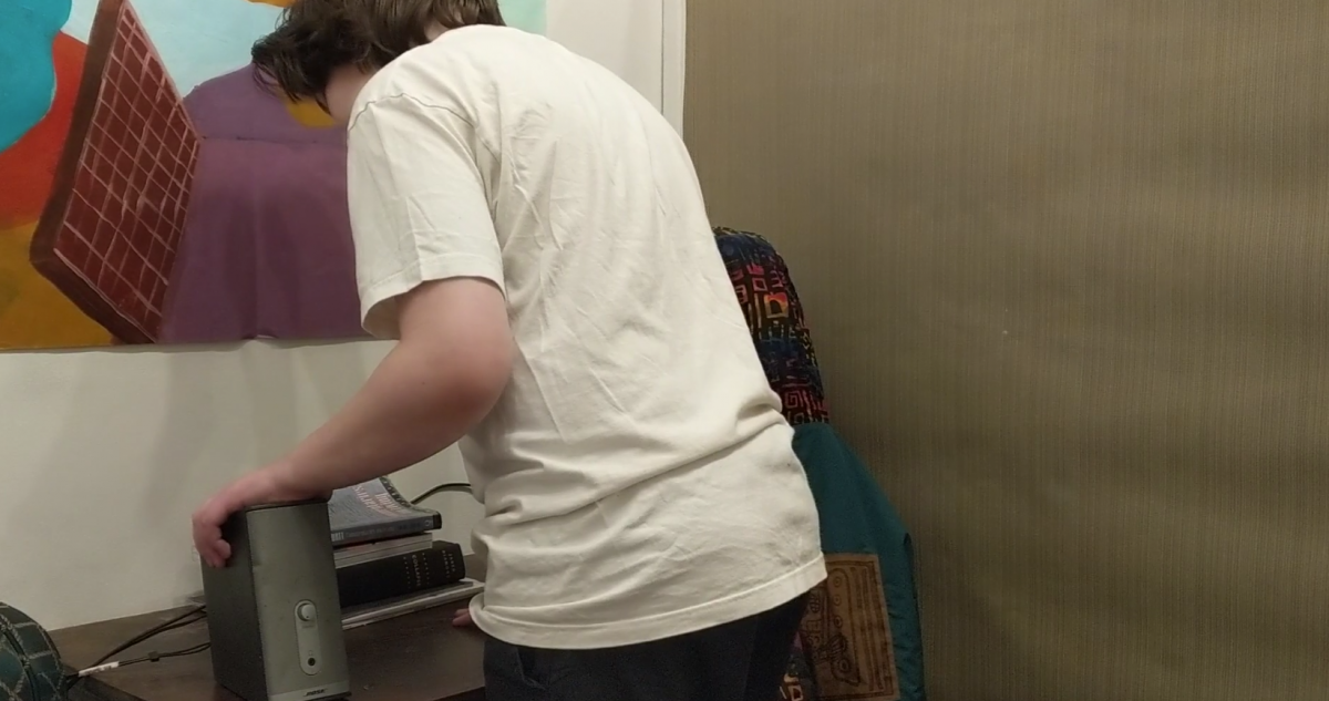 Person in white shirt standing at desk