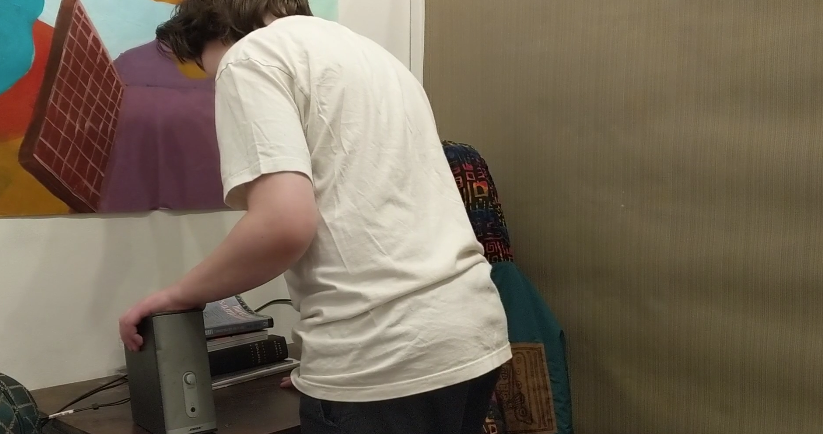 Person in white shirt standing at desk