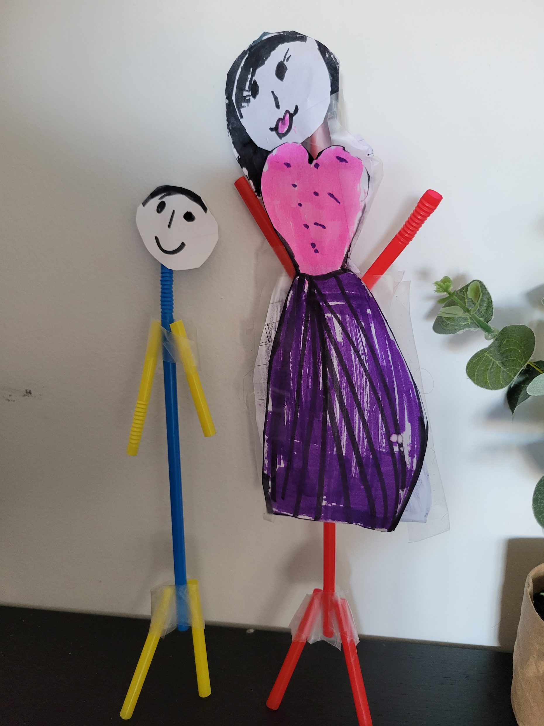 sculpture of 2 people made of pipe cleaners and paper