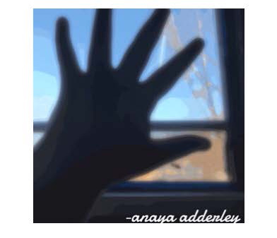 Photograph of hand in front of window