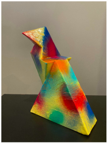 sculpture of triangular shapes with spray painted colorful circles