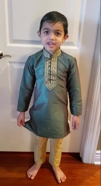 Young man standing in front of a door on a red carpet