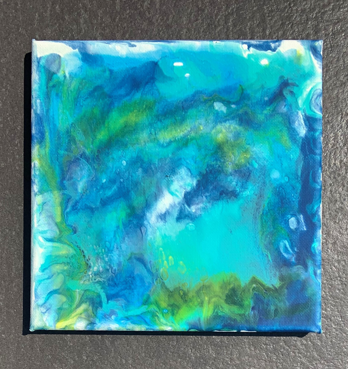 abstract painting of blues and greens, looks marbled.