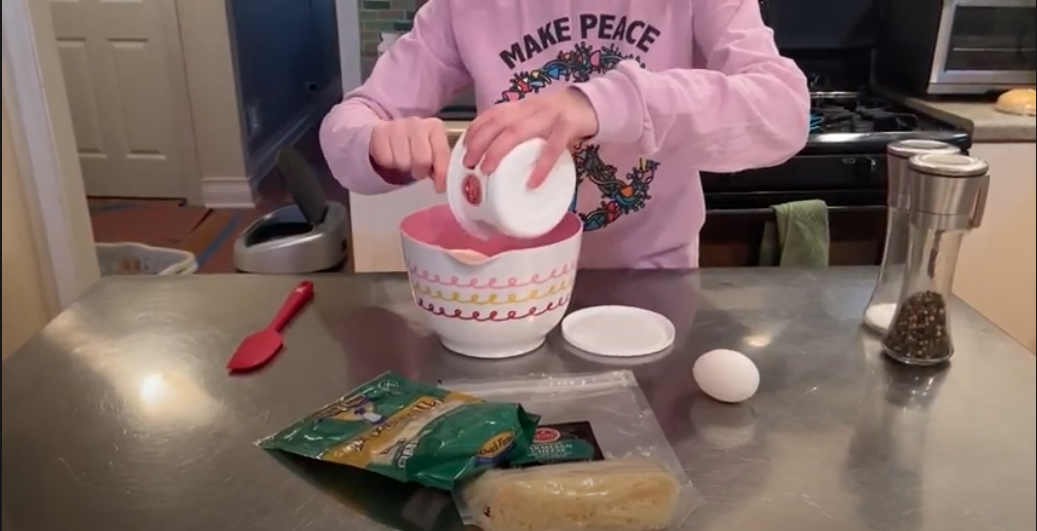 Image of person in a kitchen preparing a pasta dish.