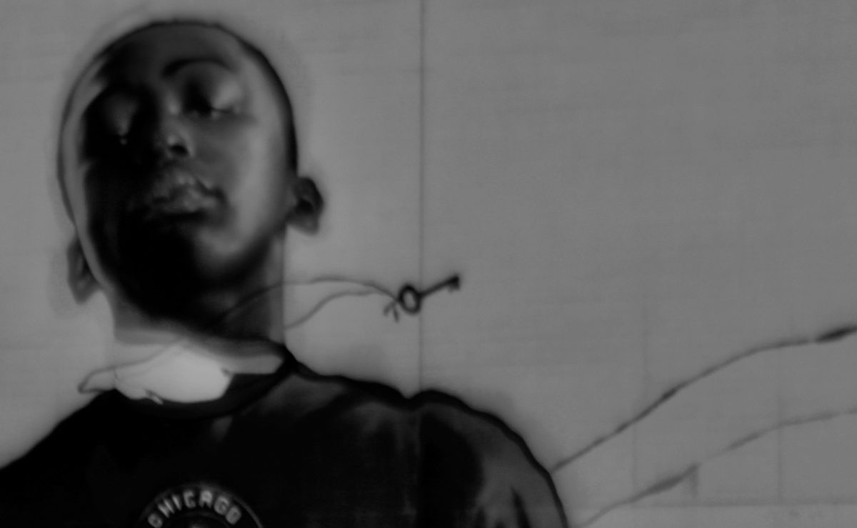 black and white photograph of a young man wearing a black sweater