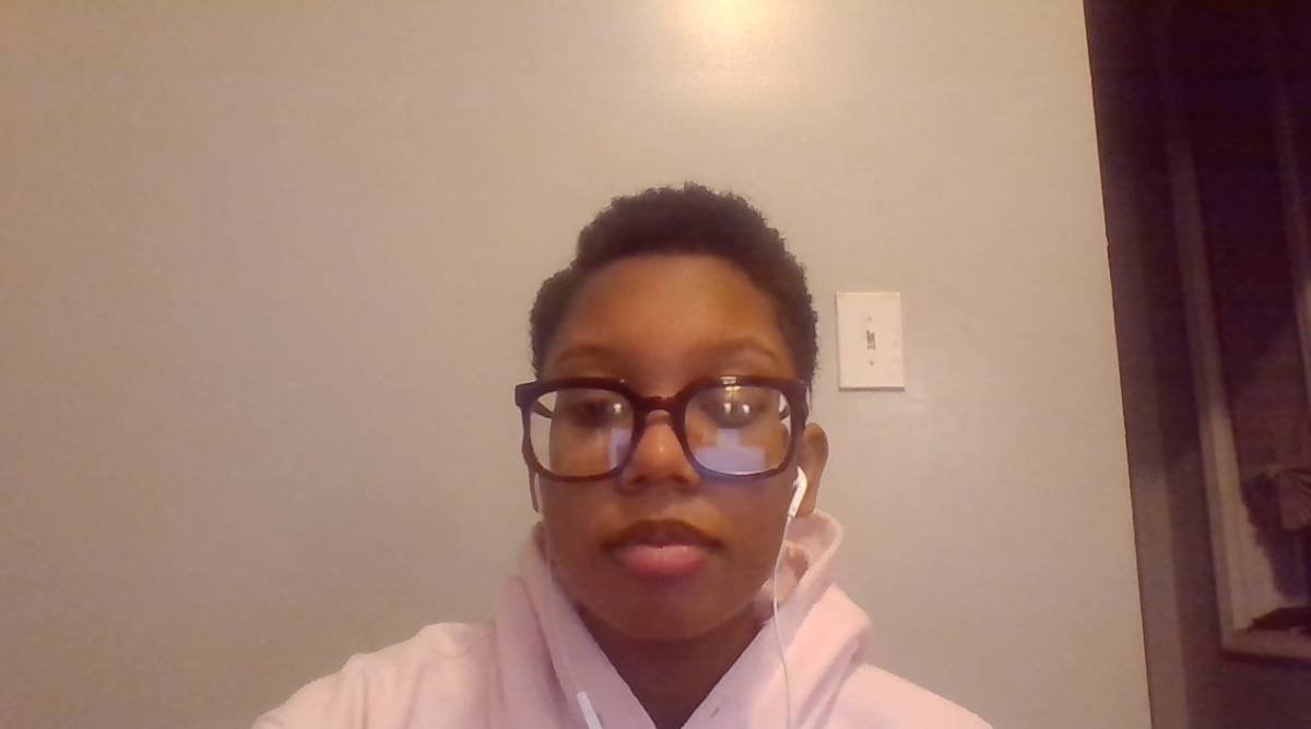 Picture of a person wearing glasses with headphones in