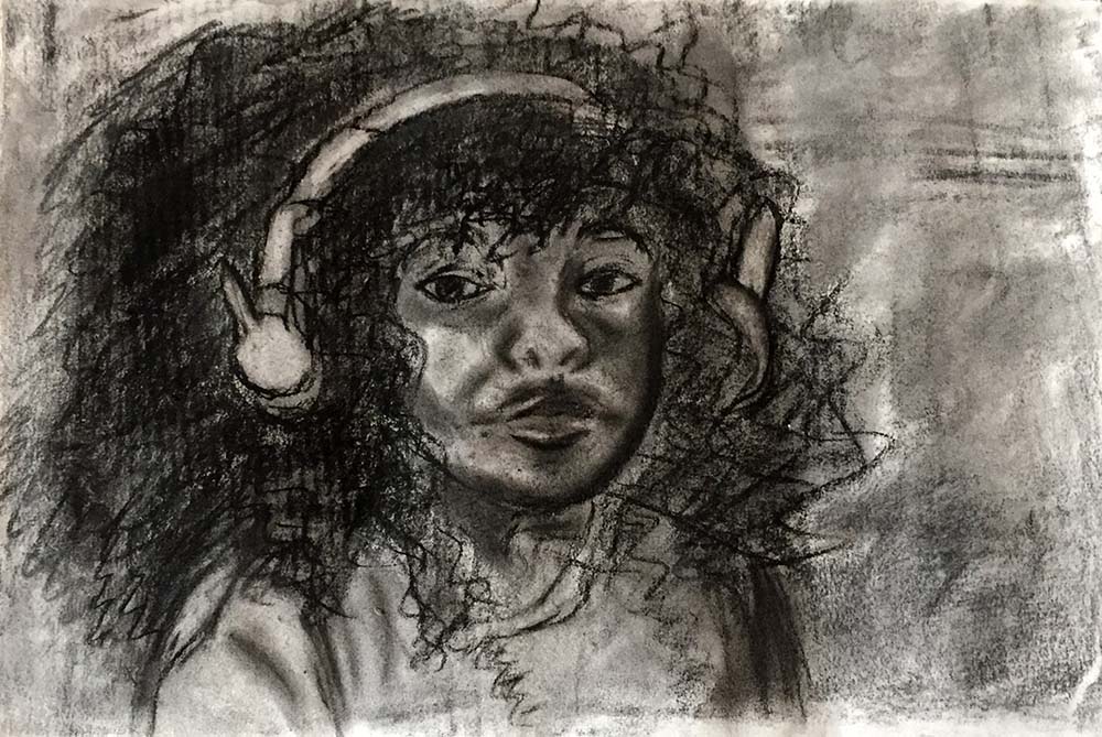 Portrait of person with curly hair wearing headphones