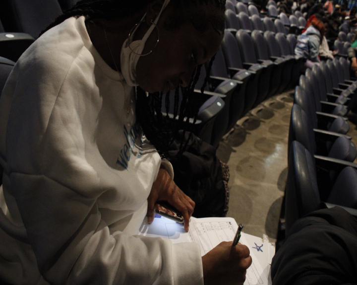 Photograph of a person in an auditorium