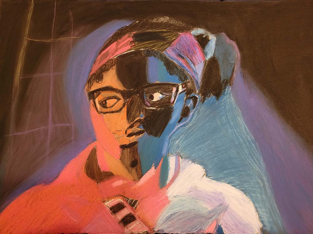 Portrait of person with a ponytail and glasses looking to the left.