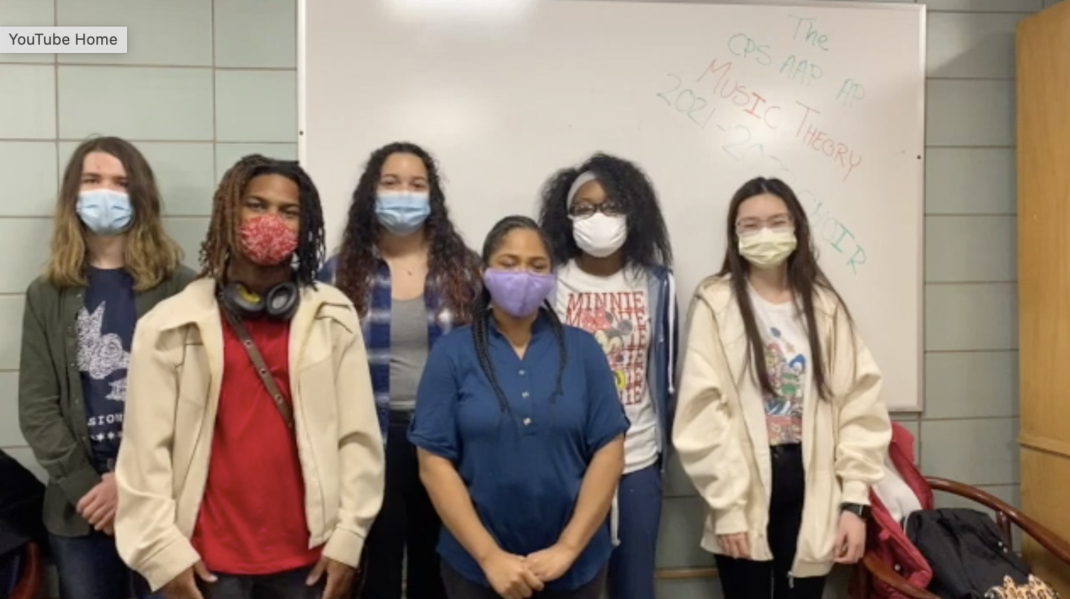 Students with masks looking at camera