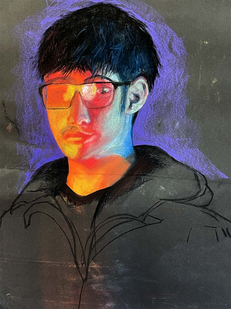 Portrait of person with short, dark hair and glasses