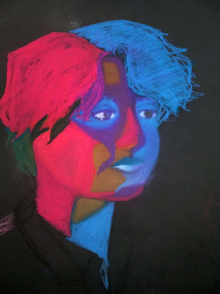 Person with short hair, in blue and purple