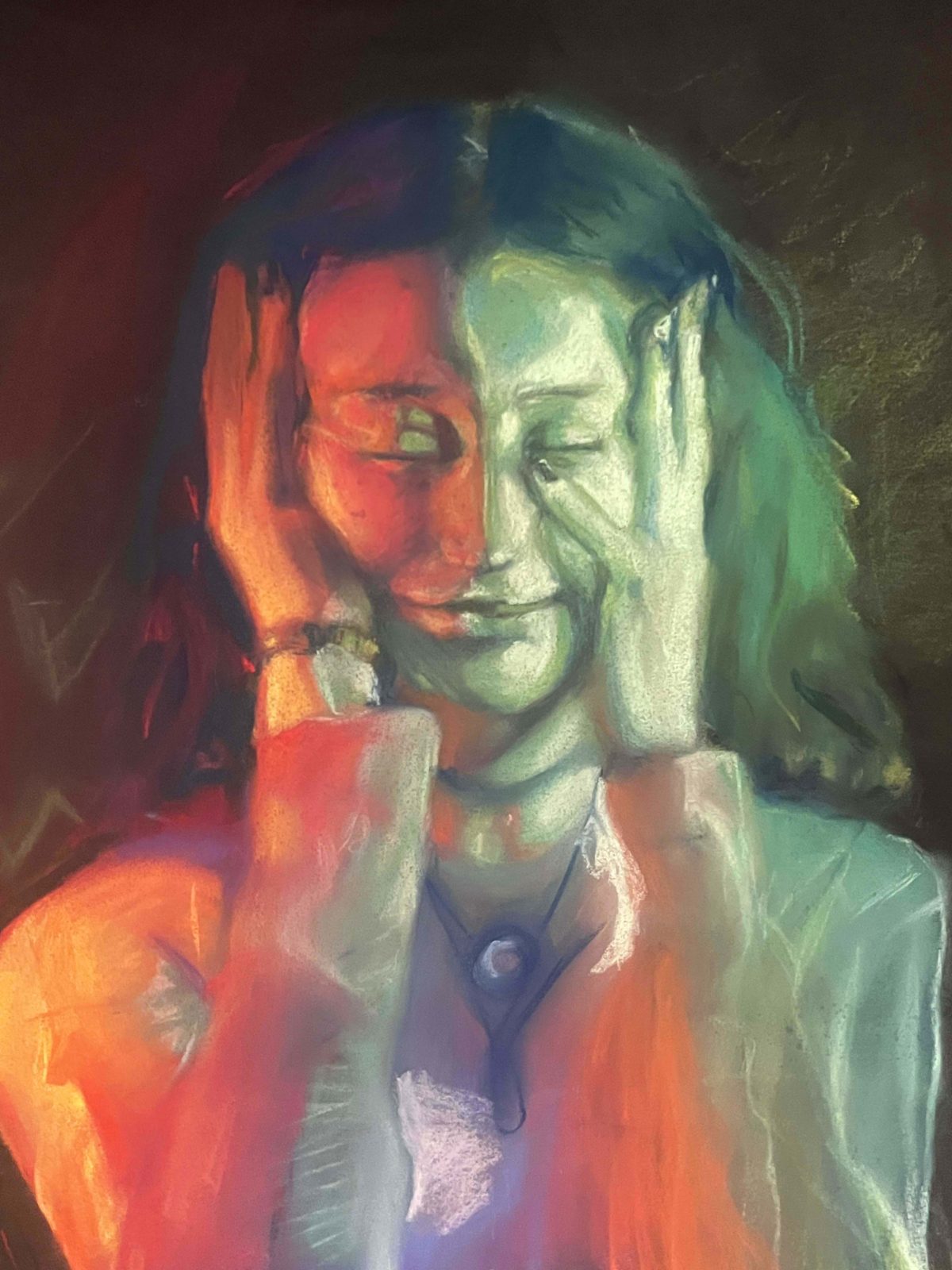 Person with their eyes closed, holding their face in their hands