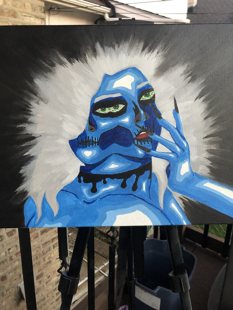 blue and white painting of an abstract face with a hand with long nails