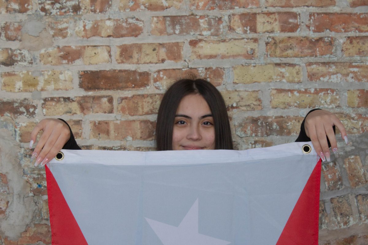a photograph of a young woman holding up a Puerto Rican Flag