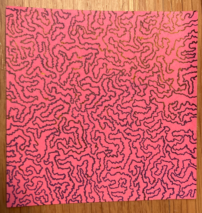Abstract black drawing on a red post-it note