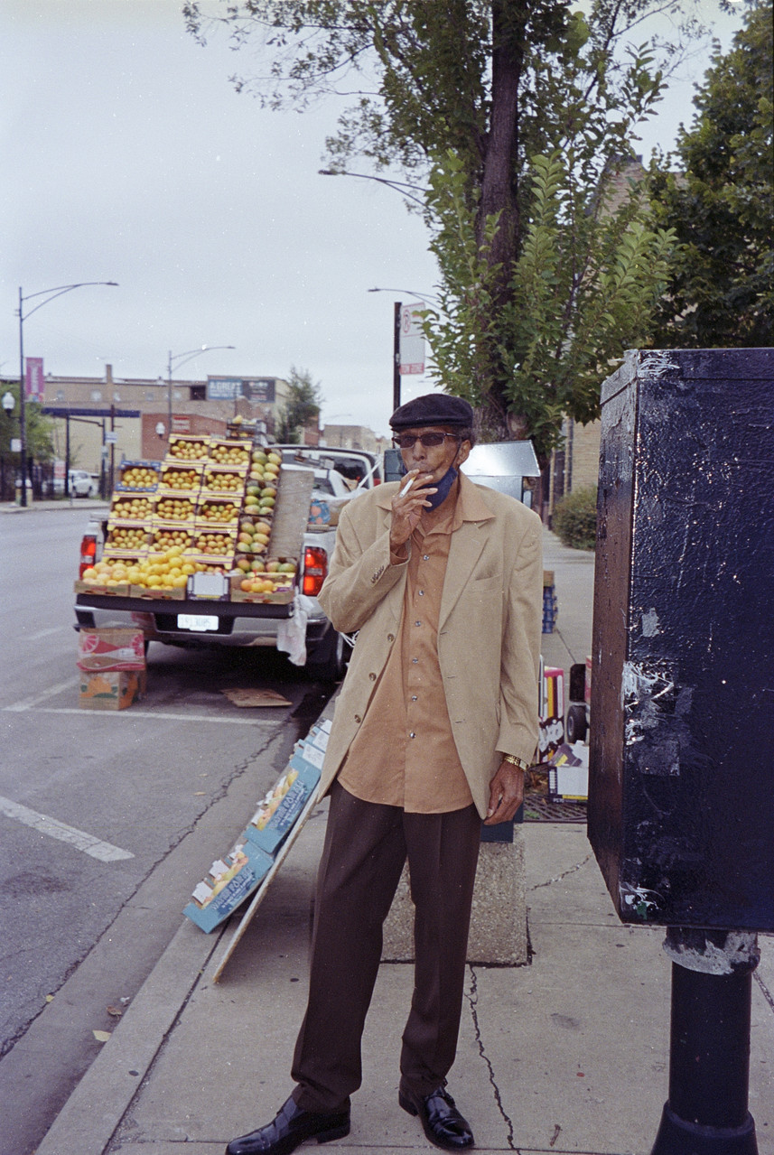 Photograph of a man smoking a cigarette