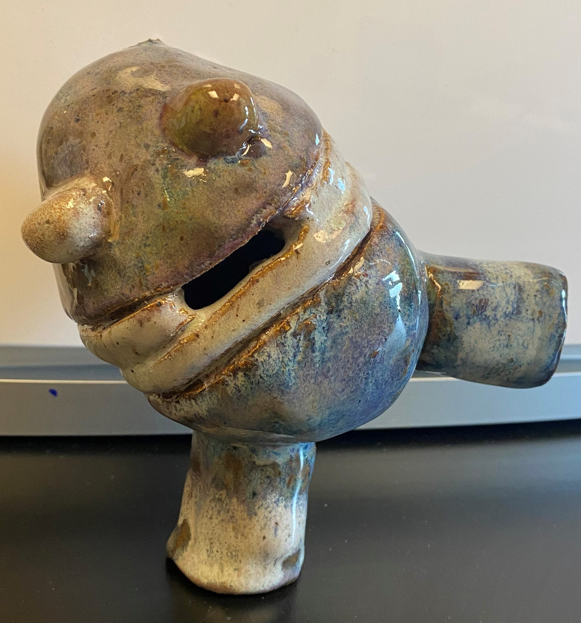 Ceramic robot character standing on one foot