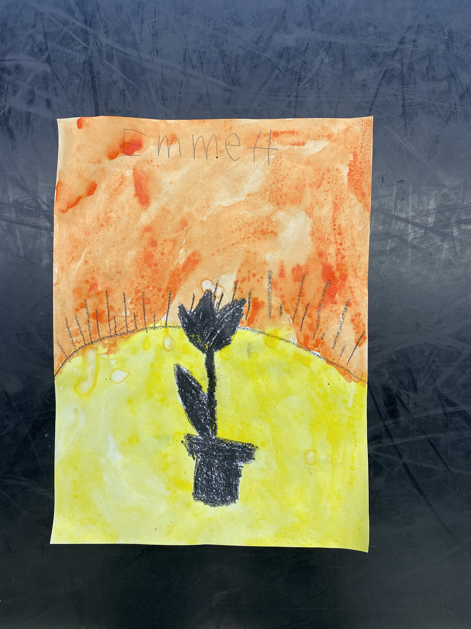 A flower on a yellow surface