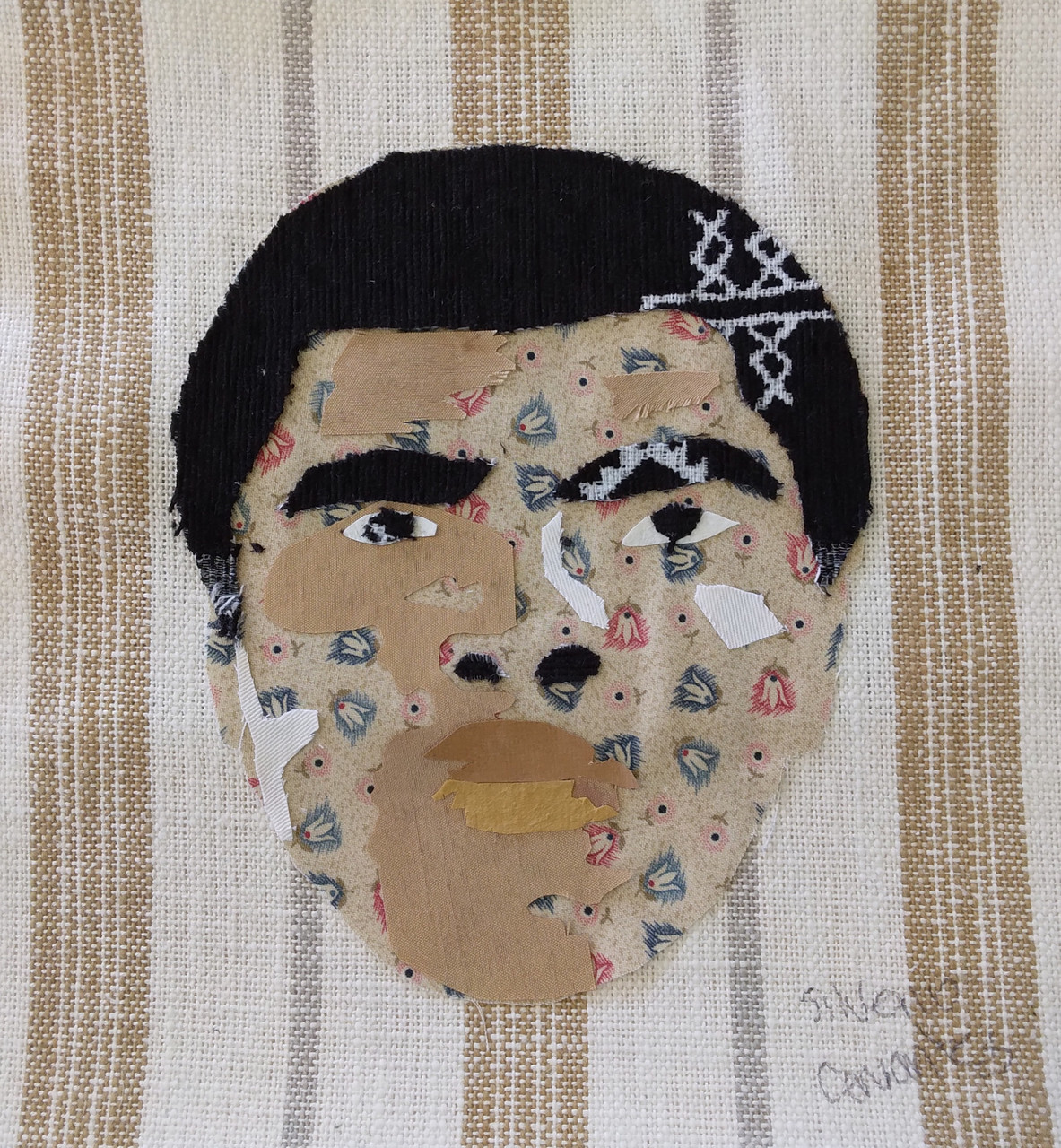 Mixed Media of Muhammad Ali's face with tan and white background