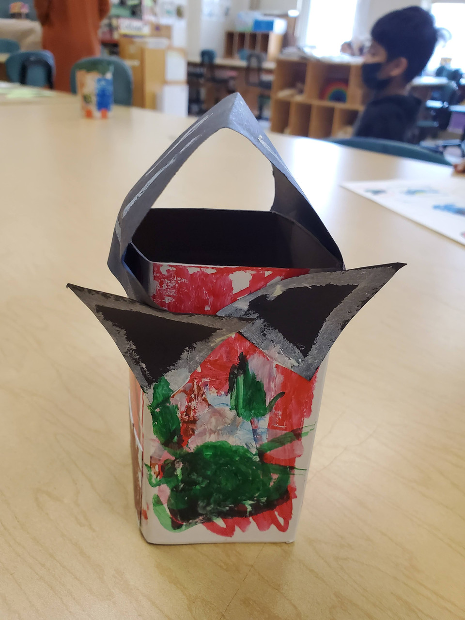 cardboard sculpture red and green with cat ears