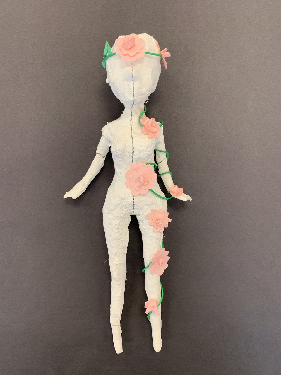 Sculpture of a figure with flowers on it