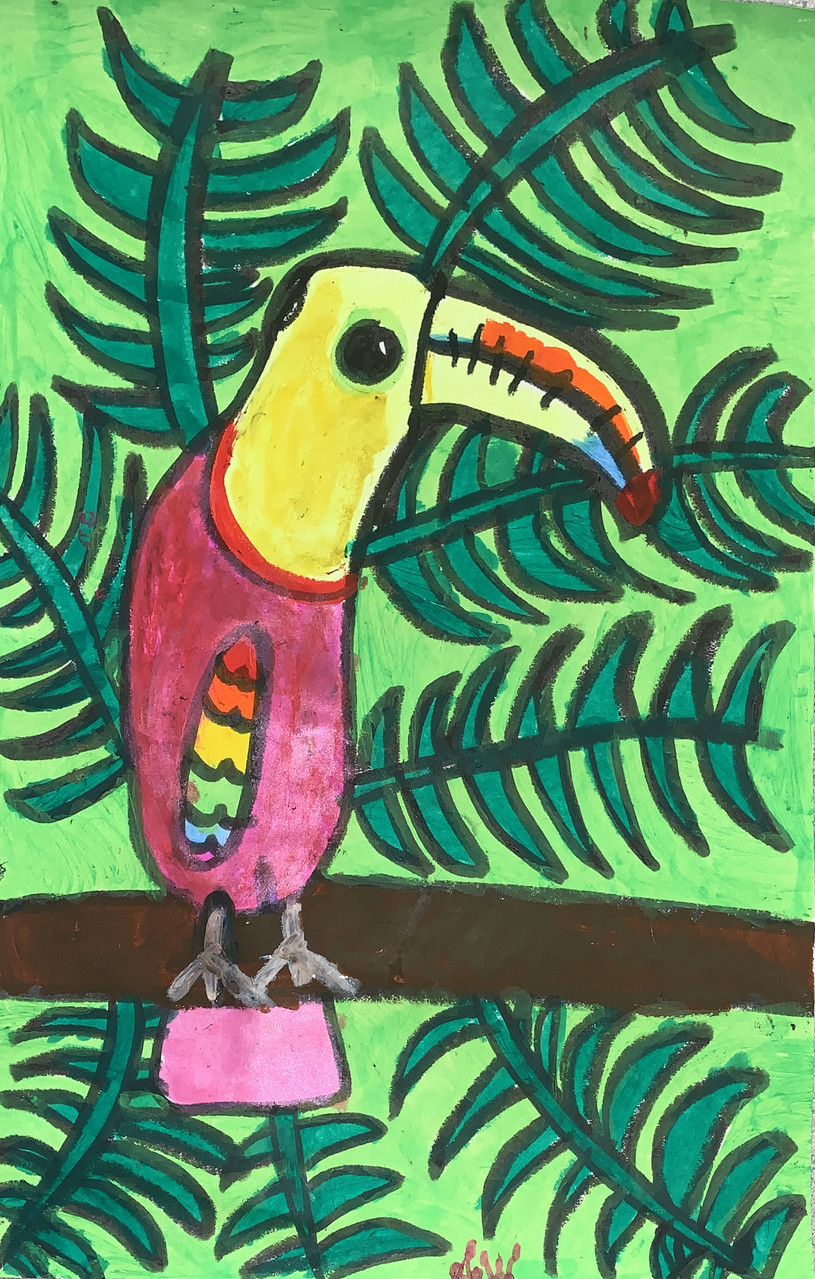 toucan sitting on branch with green leaves in the background