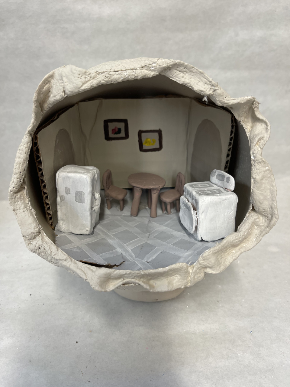 Terrarium scene of a kitchen with everything made of clay